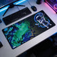 Desk setup with a large mouse pad featuring an astronaut design, keyboard, and mouse.