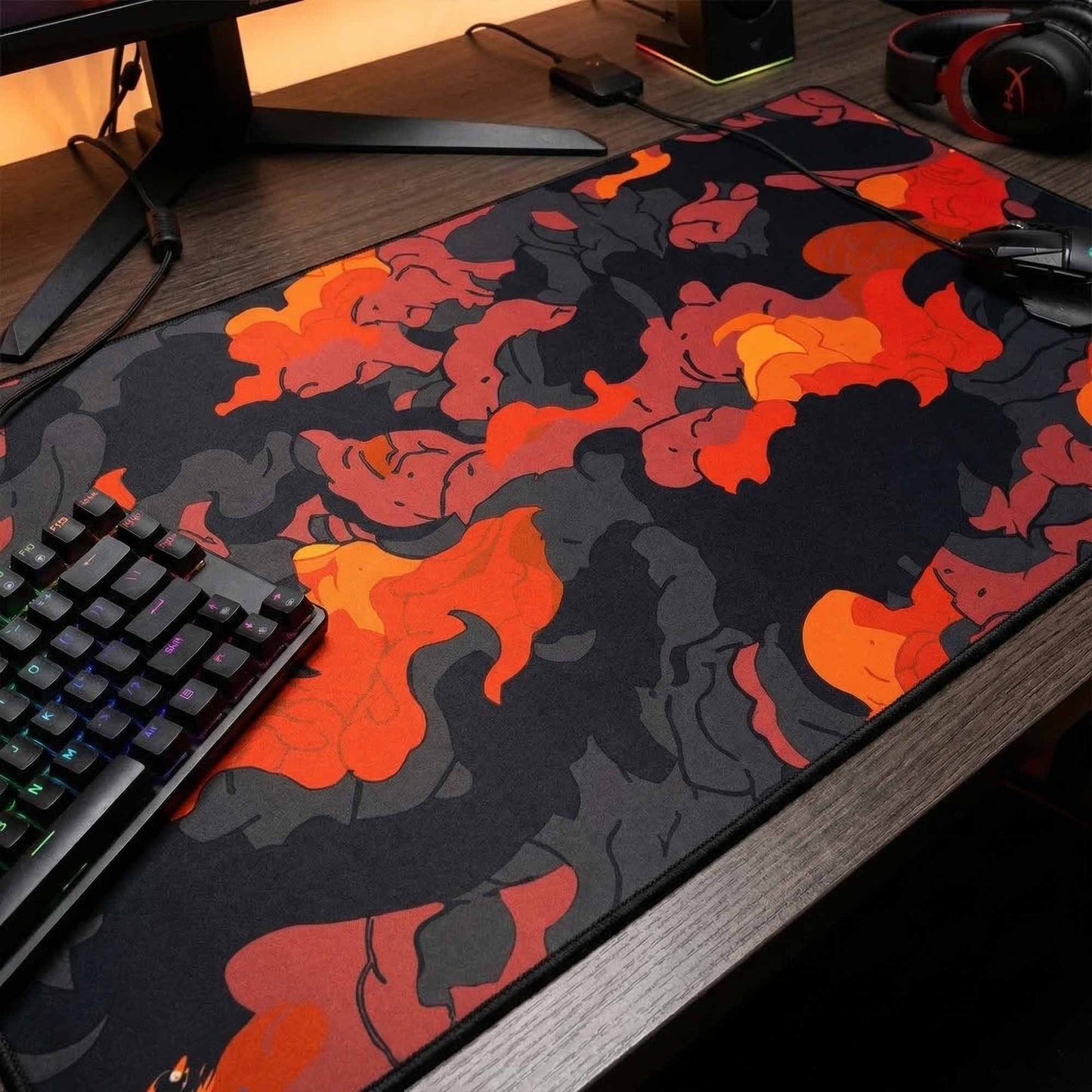 Mouse pad with fiery design on a desk next to a keyboard
