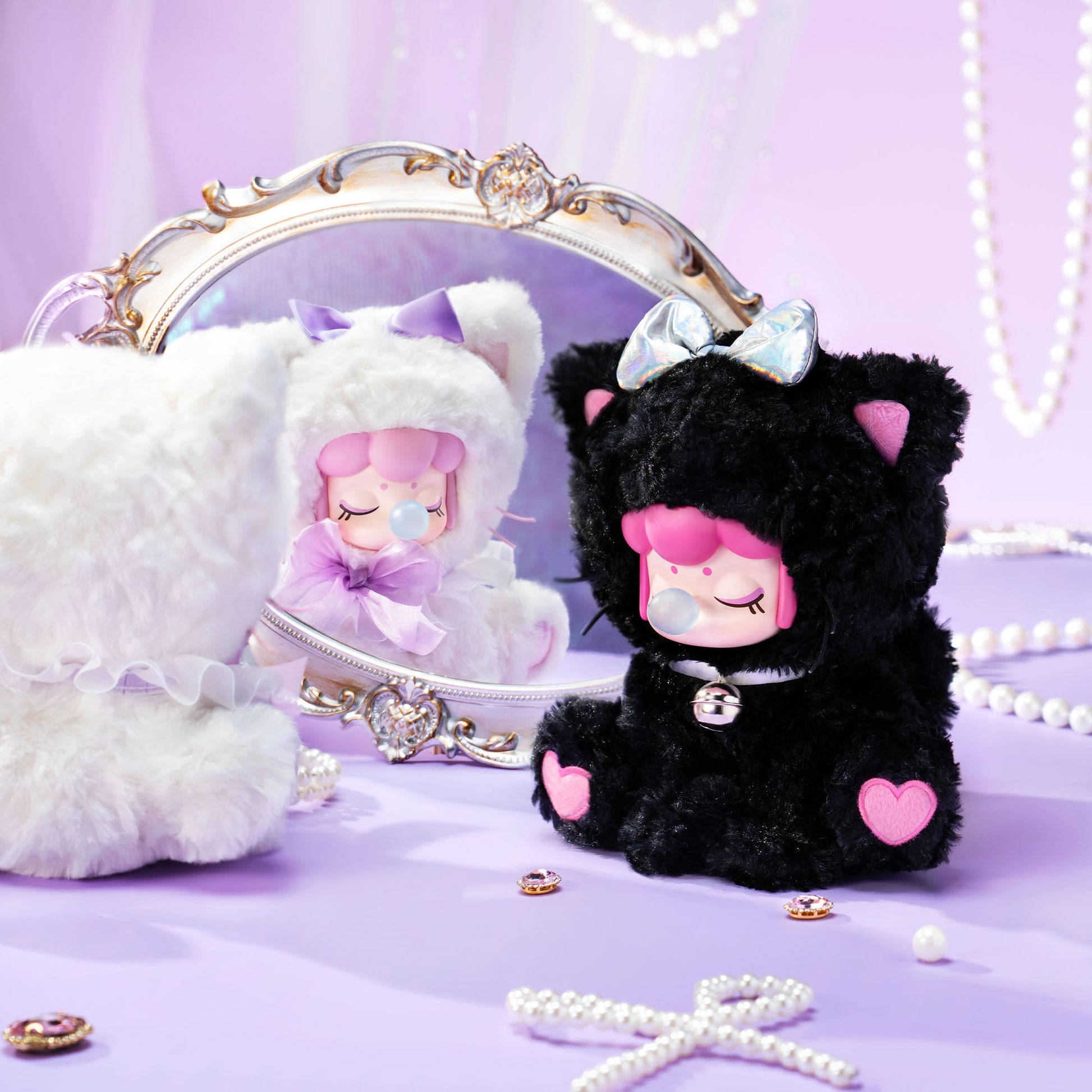 Black plush toy with pink accents and a white mirror on a purple background