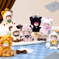 Collection of plush toys with animal-themed costumes on a checkered floor.