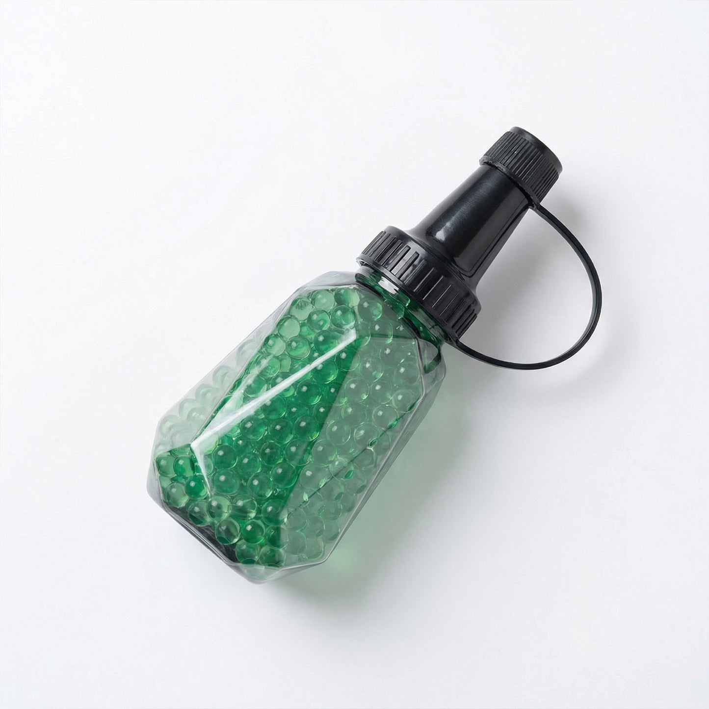 Spray bottle with green beads on a white background