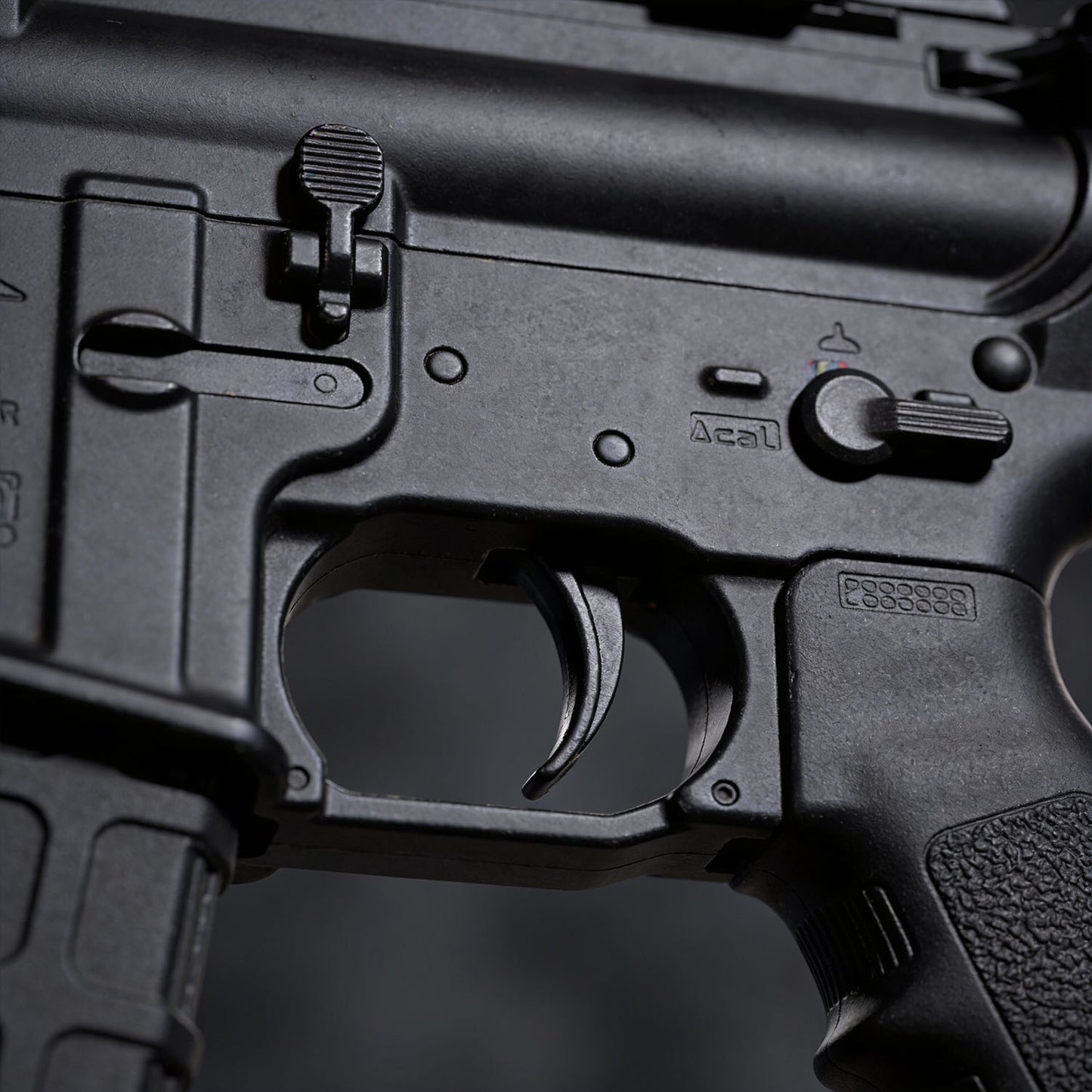 Close-up of a black firearm with visible branding