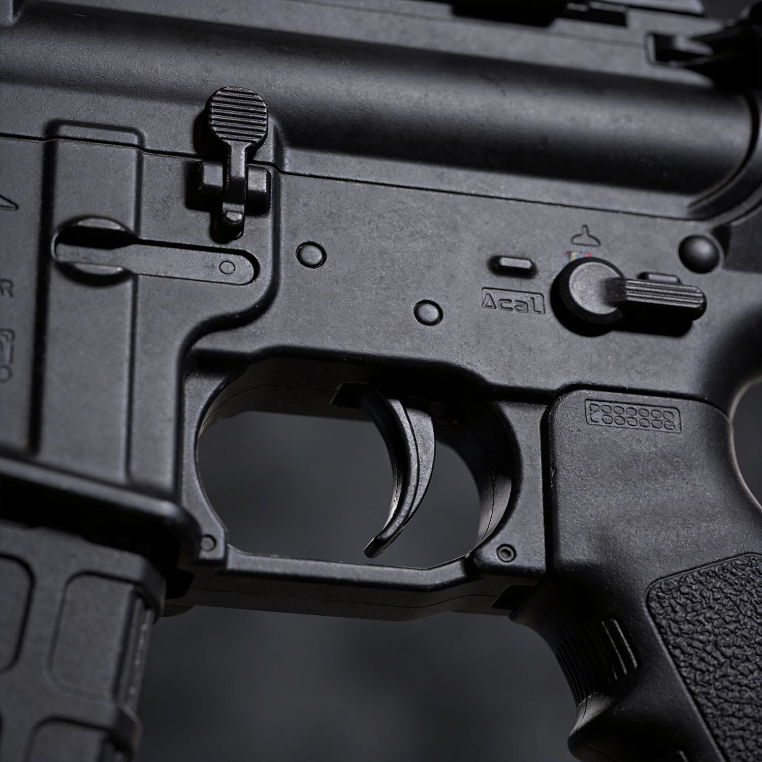 Close-up of a black firearm with visible branding