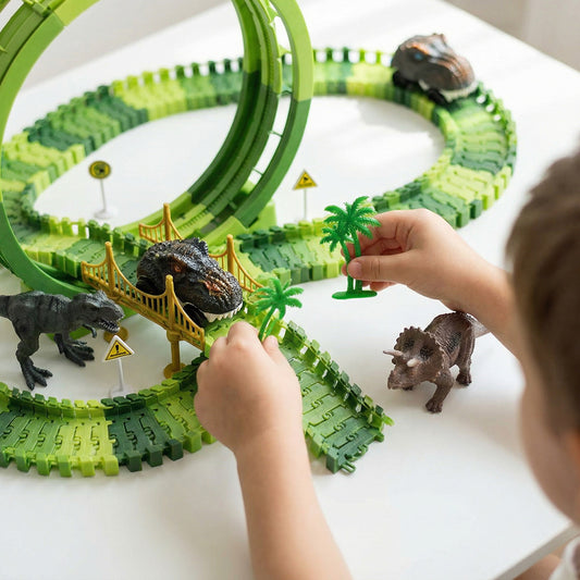 Child playing with a toy dinosaur track set