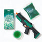 Green and black gel ball gun with packaging and green gel balls on a white background