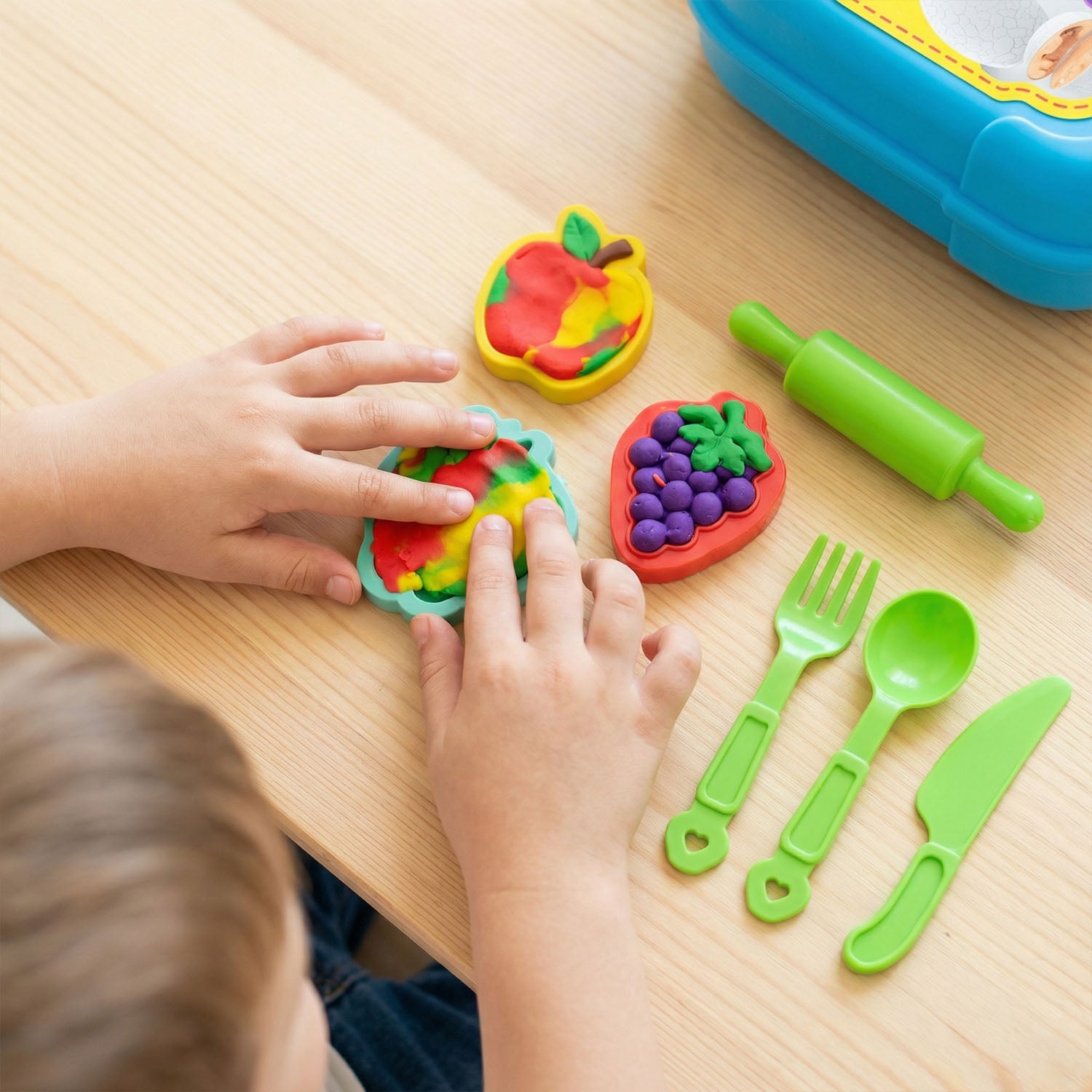 Children modeling clay toy set with food molds