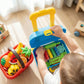 Child playing with colorful toy kitchen set on a wooden floor