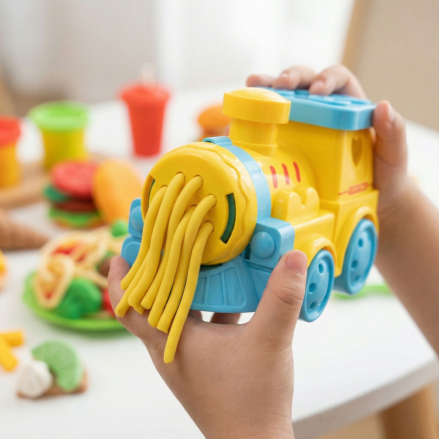 Children modeling clay train toy with accessories