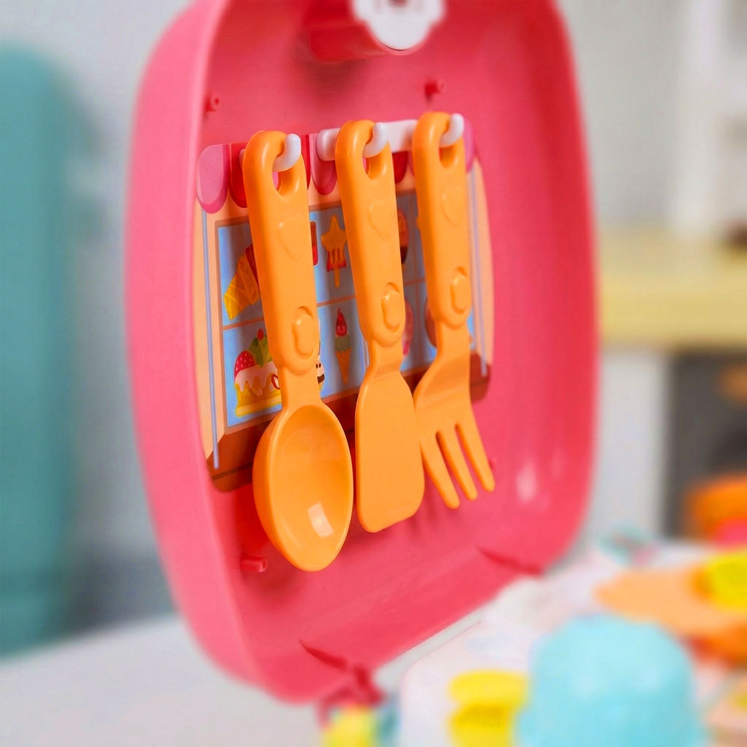 Colorful toy set with orange utensils in a pink case 