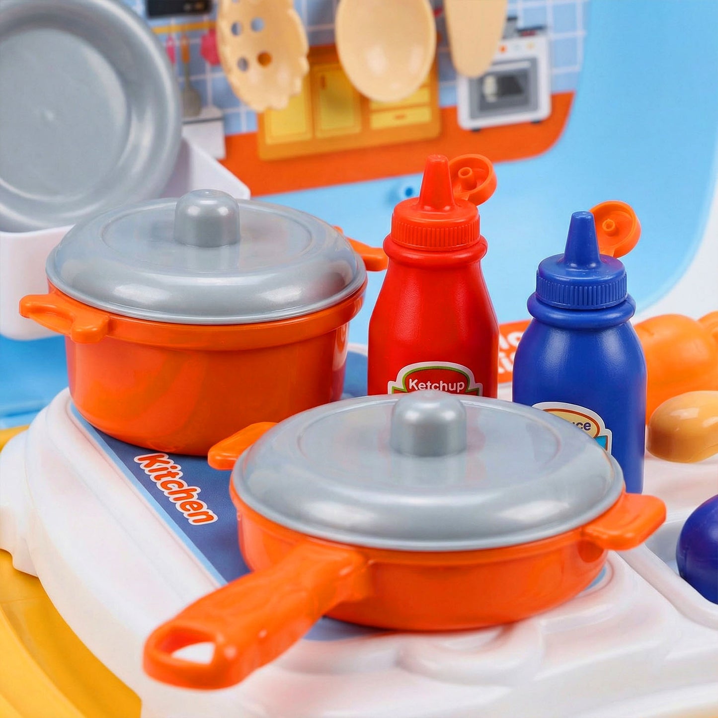 Toy kitchen set with pots, pans, and condiment bottles 