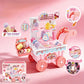 Toy ice cream cart with various toy ice creams and a box on a pink background