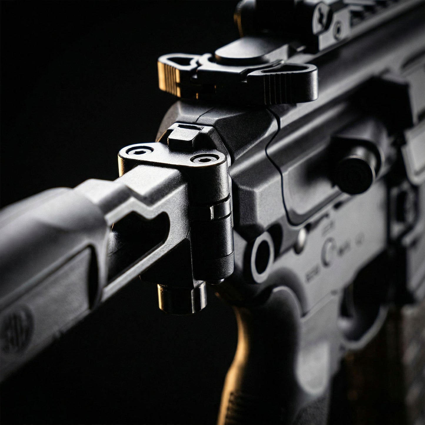 Close-up of a rifle with a scope on a dark background