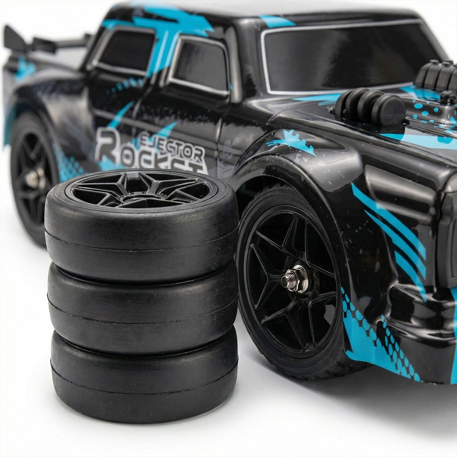 Black and blue remote control car with spare tires on a white background